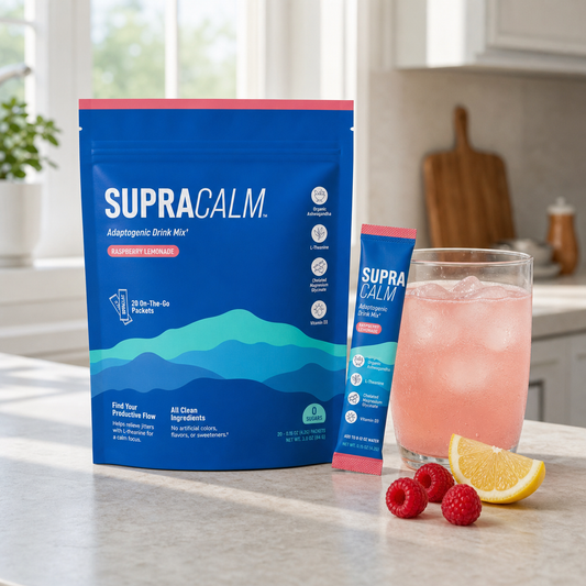 SUPRACALM Raspberry Lemonade drink mix in a bright morning kitchen with a pink iced drink